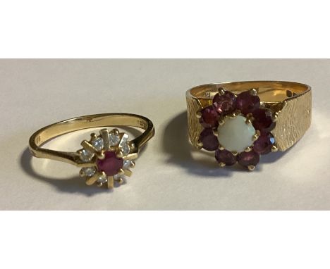 A small ruby and diamond cluster ring together with one other. Approx. 6 grams. Est. £80 - £120.