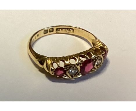 An attractive ruby and diamond five-stone ring in 18 carat gold carved mount. Approx. 4 grams. Est. £150 - £200.