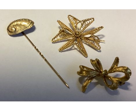 A 9 carat stick pin, brooch etc. Approx. 9 grams. Est. £100 - £150.