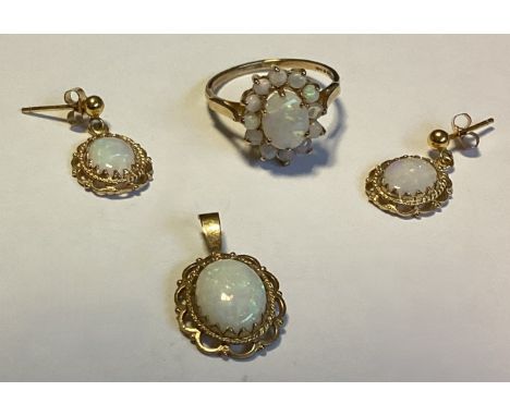 A 9 carat opal mounted ring together with matching pendant and earrings. Approx. 5 grams. Est. £70 - £80.
