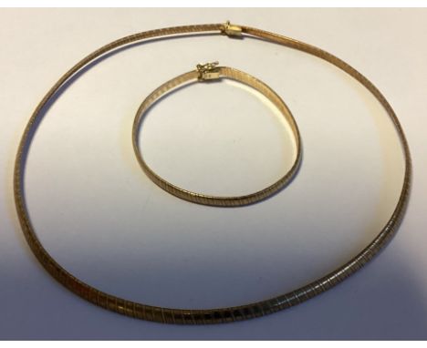 A boxed 9 carat fine link necklace together with a bangle. Approx. 16 grams. Est. £150 - £200.