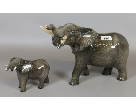 A large Beswick model of an elephant with out stretcher trunk standing 26 cm tall along with its calf.