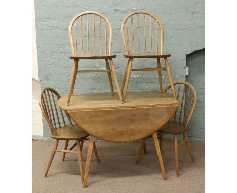 A Golden Dawn Ercol dropleaf dining table and set of four spindle back chairs.