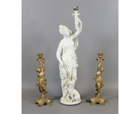 A painted figural lamp base formed as a lady and greyhound along with a pair of gilt painted figural candlesticks, applied ma