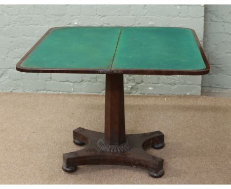 A Victorian mahogany card table with scroll decoration standing on an octagonal support and pad feet.