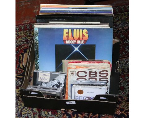 A box of records, singles and C.Ds to include Elvis, Roy Orbison, Jim Reeves, Tony Christie, Status Quo, U2, Eric Clapton etc