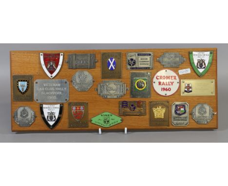 A wooden plaque and collection of vintage car rally badges including enamel examples 1950s and 60s.