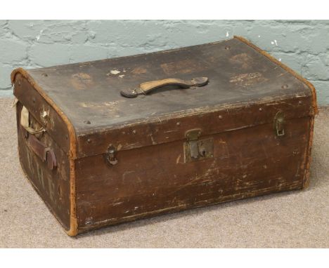 A vintage leather travelling trunk inscribed B.H.E.