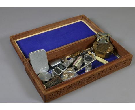 A carved hardwood and inlaid box and contents of collectables to include various wristwatches, lighters, military buttons and