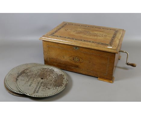 A walnut cased polyphon disc playing music box and 16 discs. Discs 30.5cm diameter. Condition Report. To be used as a guide o