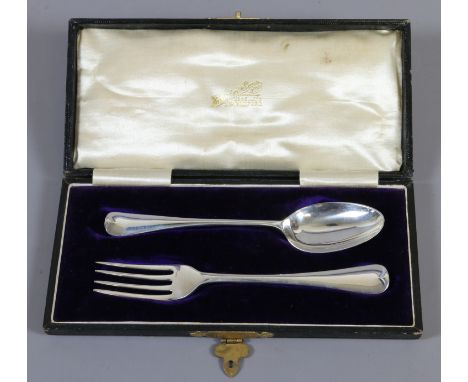 A cased assembled silver christening set fork and spoon, assayed Birmingham, 50 grams.
