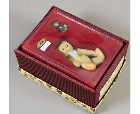 A Steiff collection 100 years composite bear in box with an accompanying monkey.