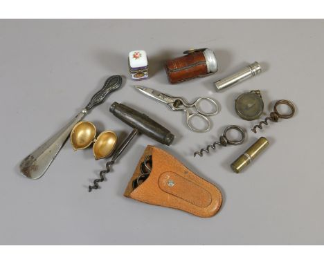 A tin of collectables to include, corkscrews, compass etc.