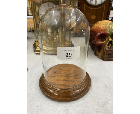 A VINTAGE GLASS CLOCHE / DOME ON OAK WOODEN BASE 