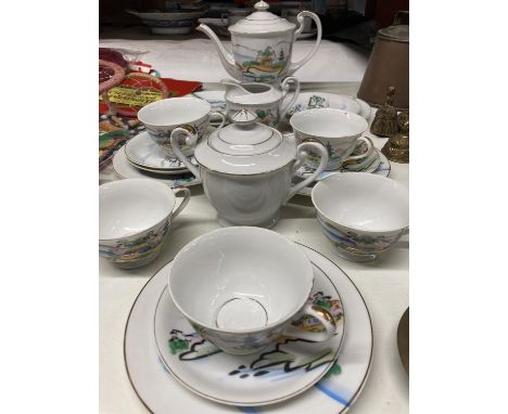 AN ORIENTAL TEASET WITH A GEISHA GIRL SILHOUETTE IN THE CUPS TO INCLUDE TEAPOT, CREAM JUG, SUGAR BOWL, CUPS, SAUCERS AND SIDE