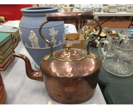 A VINTAGE BRASS AND COPPER KETTLE 