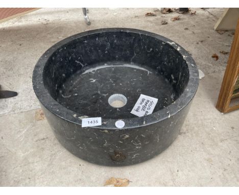 A SOLID BLACK MARBLE WASH BASIN 