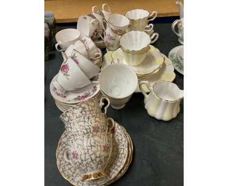 A QUANTITY OF VINTAGE TEAWARE TO INCLUDE A YELLOW AND WHITE FLUTED DESIGN, ROSE PATTERNED, ETC - CUPS, SAUCERS, SIDE PLATES, 
