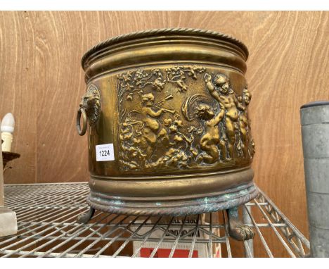 A VINTAGE BRASS PLANTER WITH CHERUB DESIGN, LION HEAD HANDLES AND LION PAW FEET (H:25CM D:27CM) 