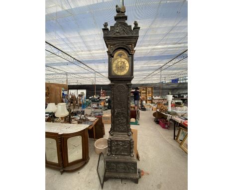 A JOHN DAY EIGHT-DAY LONGCASE CLOCK WITH BRASS ROLLING MOON FACE, PROFUSELY CARVED WITH MYTHICAL MEDIEVAL SCENES AND PHRASES,