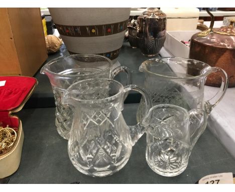 FOUR VINTAGE GLASS WATER JUGS WITH ETCHED AND CUTGLASS DESIGN 