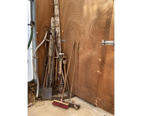 A LARGE ASSORTMENT OF VINTAGE GARDEN TOOLS TO INCLUDE FORKS, SPADES AND RAKES ETC 