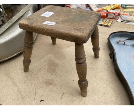 A VINTAGE WOODEN FOUR LEGGED MILKING STOOL 