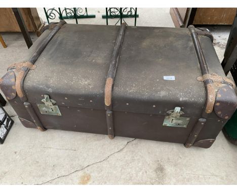 A LARGE VINTAGE TRAVEL TRUNK WITH WOODEN BANDING 