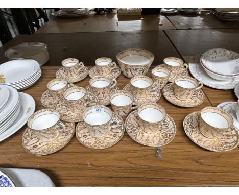 AN ANTIQUE BEIGE WHITE AND GOLD TEASET CONSISTING OF MAINLY CUPS AND SAUCERS WITH SUGAR BOWL 