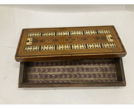 AN MAHOGANY CRIBBAGE BOARD INLAID WITH BONE CROSS BANDING 