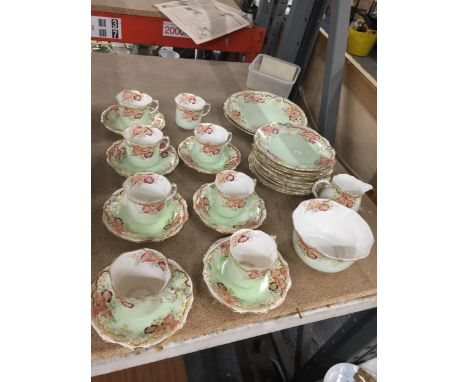 A VICTORIAN TEASET IN PALE GREEN WITH FLORAL PATTERN TO INCLUDE A CAKE PLATE, CUPS, SAUCERS, SIDE PLATES, A CREAM JUG AND SUG