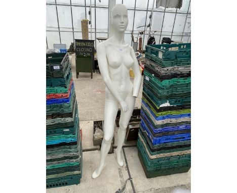 A FEMALE LIFE SIZE MANNEQUIN MISSING A HAND 