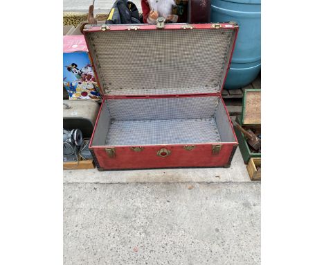 A RED VINTAGE TRAVEL TRUNK 