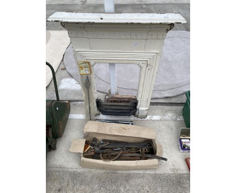 A CAST IRON FIRE SURROUND AND AN ASSORTMENT OF TOOLS 