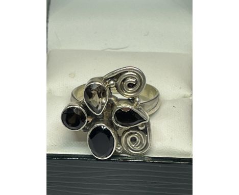 A SILVER DESIGNER RING IN A PRESENTATION BOX 
