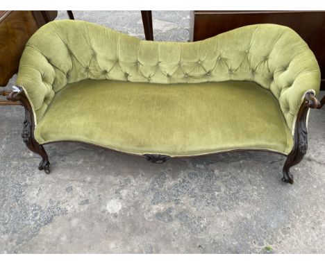 A VICTORIAN MAHOGANY SCROLL END COUCH ON CABRIOLE LEGS WITH FOLIATE CARVING AND BUTTON BACK 