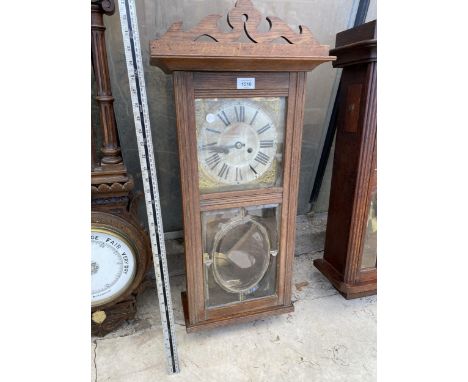 A VINTAGE OAK CASED CHIMING WALL CLOCK 
