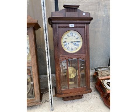 A VINTAGE OAK CASED 'F G RUSSELL' CHIMING WALL CLOCK 