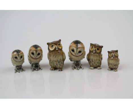 A collection of six hallmarked silver and enamel owl figures.