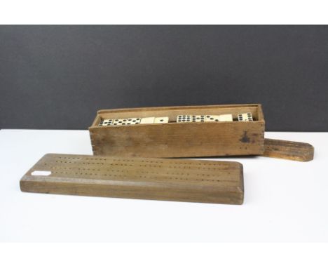 A set of bone double nine dominoes together with two wooden cribbage boards.