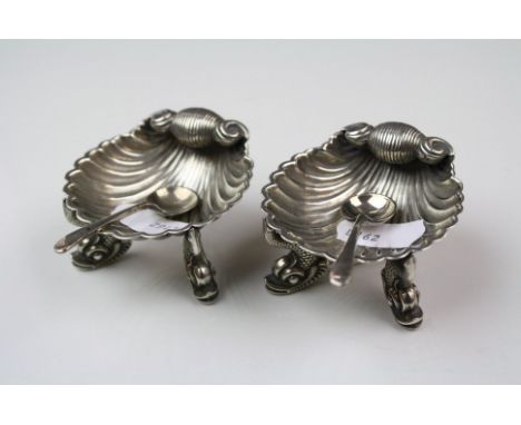 A pair of fully hallmarked sterling silver scalloped salts with oriental dolphin feet.