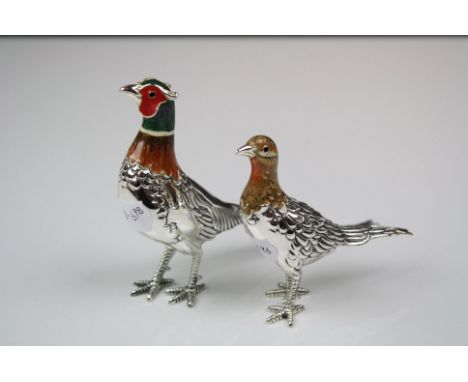 A pair of white metal and enamel cock and hen pheasant figures.