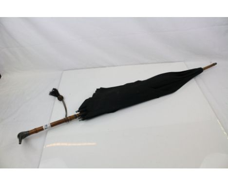 An early 20th century Army &amp; Navy CSL parasol with silver bird head handle.