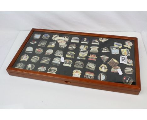 A collection of Danbury mint collectable enamel badges contained within display case.