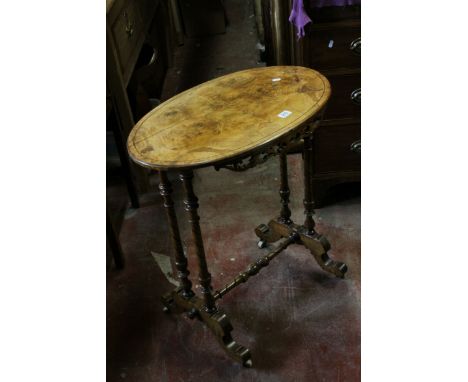 Victorian Walnut Oval Top Side Table with fretwork apron, raised on turned legs  united by a cross-stretcher, with ceramic ca