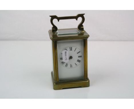 A brass cased carriage clock with white enamel dial, complete with key.