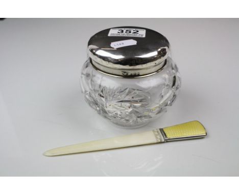 A cut glass powder jar with a fully hallmarked sterling silver lid together with a page turner with silver and guilloche enam