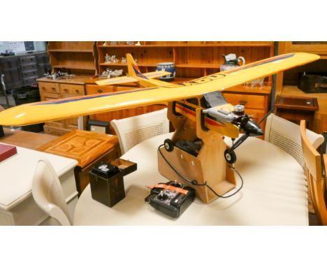 A large model airplane complete with jetex style engine with remote control unit and other spare parts etc, the plane has a 6