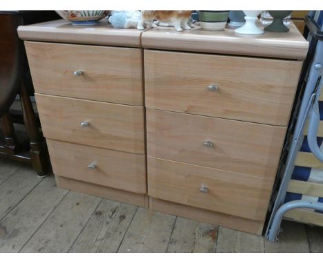 A pair of modern light pine effect three drawer bedside chests 