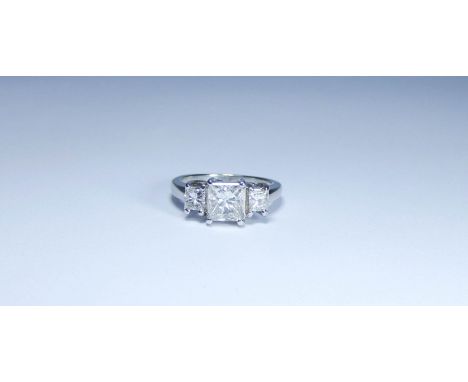 Large modern three stone diamond ring, set with a central princess cut diamond weighing 1.2 carats, with two princess cut dia